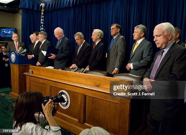 Sen. John McCain, R-Ariz., right, and other senators during a news conference after the Senate passed, 62-36, a sweeping immigration overhaul...