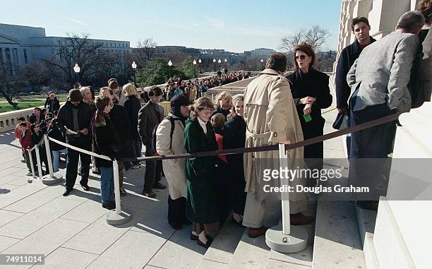 People wait in line on the south side of the U.S. Capitol to see the House Floor debate on articles of impeachment.