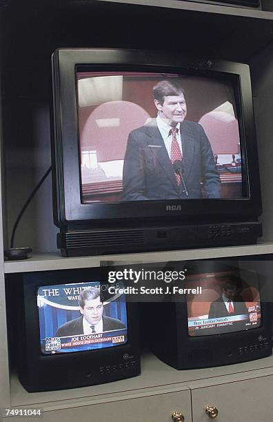 Televisions in the House Radio/TV gallery show Lamar Smith, R-Texas, during the impeachment debate on the House floor and a news conference at the...