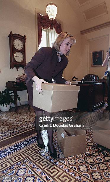 Laurie Flynn staff assistant of the Secretary of the Senate, moves boxes of evidence so photographers can take photographs of the documents from the...