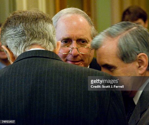 Sen. Carl Levin, D-Mich., middle, Senate Minority Leader Harry Reid, D-Nev., and Sen. Jack Reed, D-R.I., huddle before a news conference on troop...
