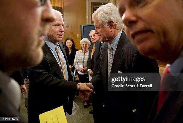 Sen. John McCain, R-Ariz., and Sen. Edward M. Kennedy, D-Mass., both in middle, and Grover Norquist, of Americans for Tax Reform, left, and Sen....