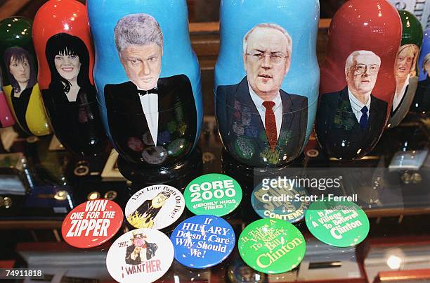 Nesting dolls of Clinton scandal personalities made by Treasures from Russia, a company in Moscow, and buttons with messages from both sides of the...