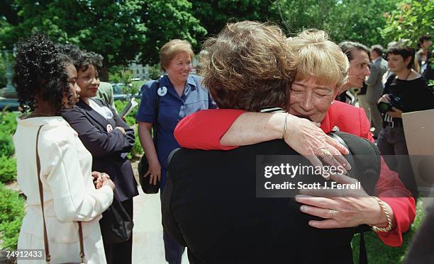 Carolyn McCarthy, D-N.Y., whose husband was killed by a gun, hugs Beckie Brown, member of The Bell Campaign Founders Council and past president of...