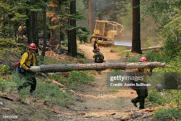 Firefighters clear debris to make a fire line in the hills behind the South Lake Tahoe high school June 25, 2007 in South Lake Tahoe, California....