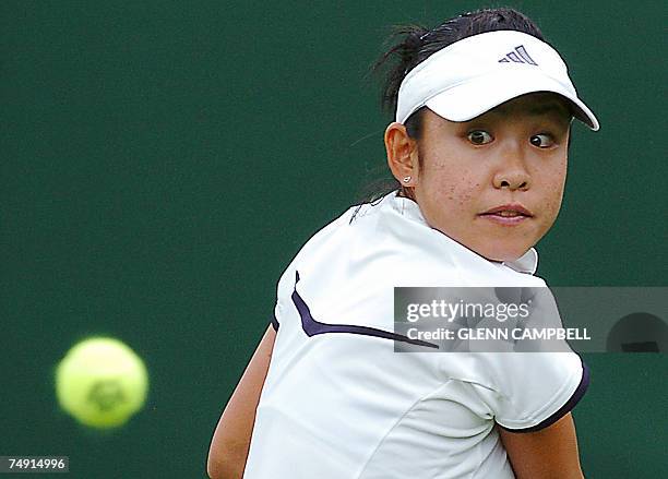 London, UNITED KINGDOM: Aiko Nakamura of Japan returns the ball to Martina Sucha of Slovakia during the first round of the Wimbledon Tennis...