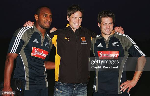 Richie McCaw and Josevata Rokocoko pose with New Zealand born AFL player Trent Croad during a New Zealand All Blacks training session at the...