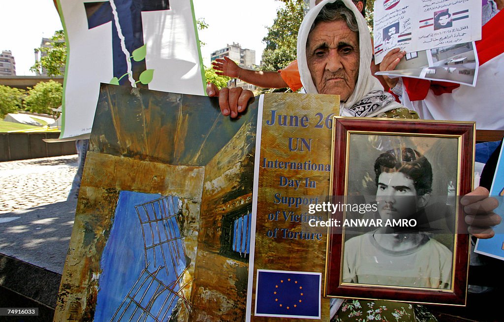 A Lebanese woman holds the picture of he...