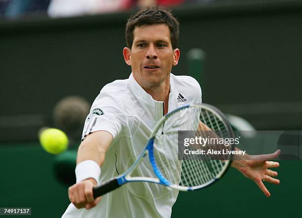 Tim Henman of Great Britain plays a backhand during the Men's Singles first round match against Carlos Moya of Spain during day two of the Wimbledon...