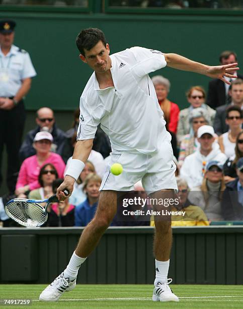 Tim Henman of Great Britain plays a forehand during the Men's Singles first round match against Carlos Moya of Spain during day two of the Wimbledon...
