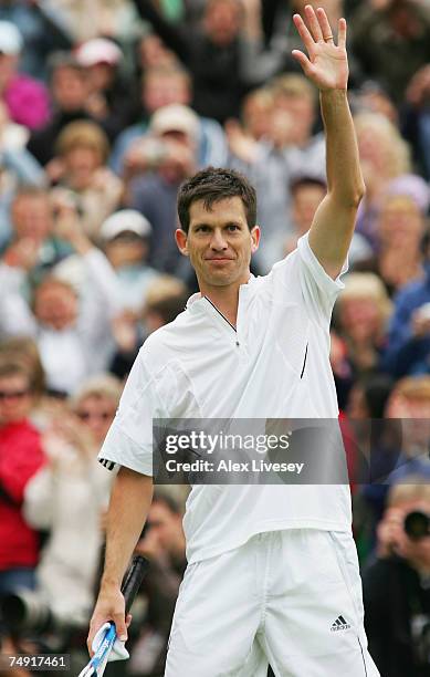 Tim Henman of Great Britain salutes the crowd following victory during the Men's Singles first round match against Carlos Moya of Spain during day...