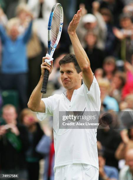 Tim Henman of Great Britain salutes the crowd following victory during the Men's Singles first round match against Carlos Moya of Spain during day...