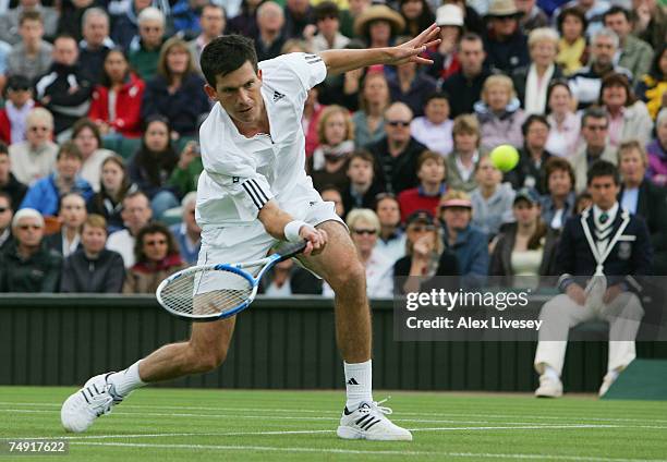 Tim Henman of Great Britain plays a forehand during the Men's Singles first round match against Carlos Moya of Spain during day two of the Wimbledon...
