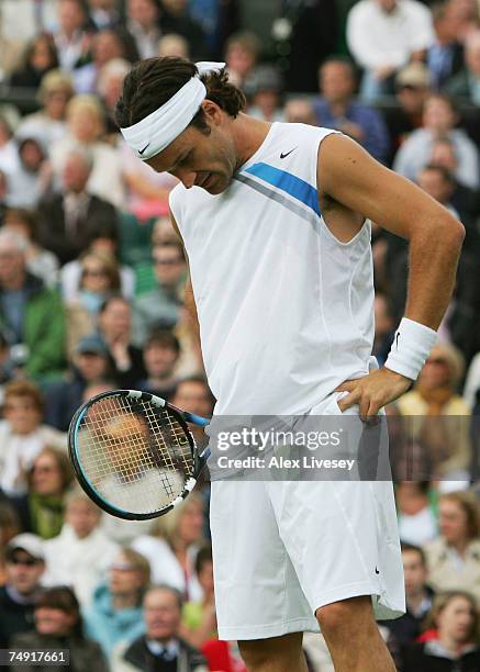 Carlos Moya of Spain looks despondent during the Men's Singles first round match against Tim Henman of Great Britain during day two of the Wimbledon...