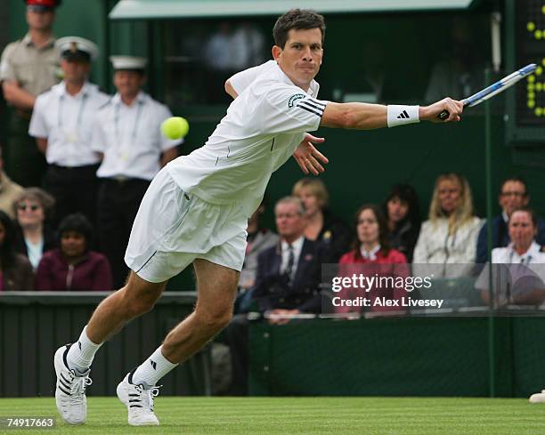 Tim Henman of Great Britain stretches to play a backhand during the Men's Singles first round match against Carlos Moya of Spain during day two of...