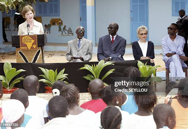 First Lady Laura Bush delivers a speech at the Grand Medine working class primary school, outside Dakar, 26 June 2007 as unidentified headmaster,...