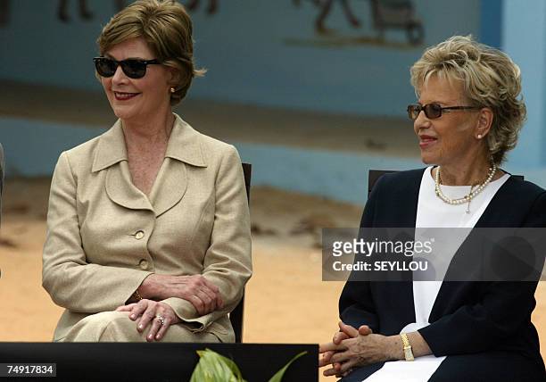 First Lady Laura Bush sits next to her Senegalese counterpart Viviane Wade during a visit to the Grand Medine working class primary school, outside...