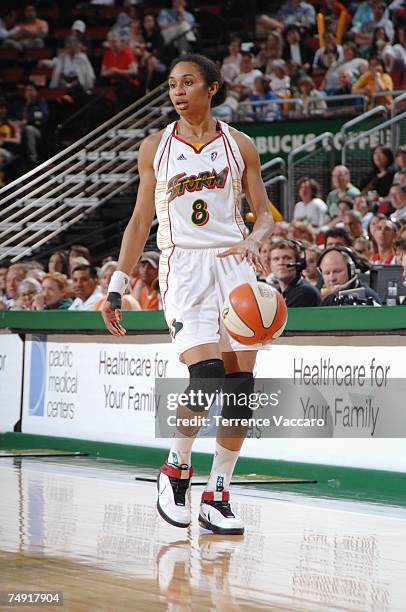 Iziane Castro Marques of the Seattle Storm moves the ball against the San Antonio Silver Stars during the WNBA game on June 2, 2007 at the KeyArena...