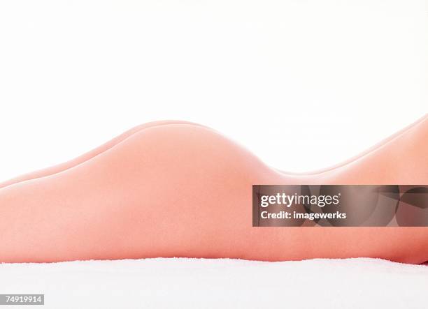 midsection of a naked woman lying on bed - bare bum stock pictures, royalty-free photos & images