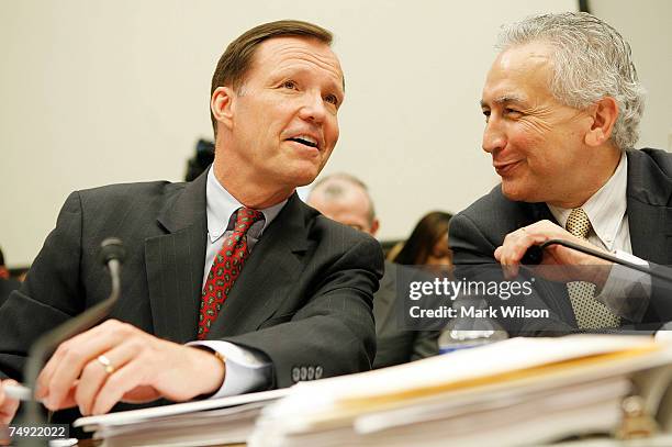 Chairman Christopher Cox talks with SEC Commissioner Roel Campos during a House Financial Services Committee hearing on Capitol Hill June 26, 2007 in...