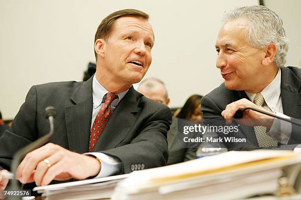 Securities and Exchange Commission Chairman Christopher Cox and Commissioner Roel Campos talk during a House Financial Services Committee hearing on...