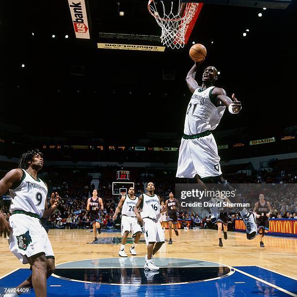 Kevin Garnett of the Minnesota Timberwolves soars for a dunk against the Memphis Grizzlies during a 2002 NBA game at the Target Center in...