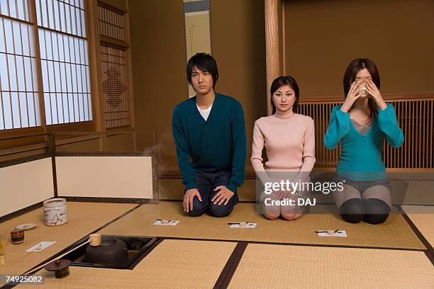 man and women sitting in tea room, one drinking japanese tea, front view, japan - bamboo dipper - fotografias e filmes do acervo