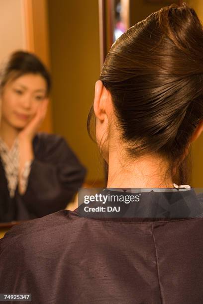 woman in yukata looking into the mirror, rear view, japan - rear view mirror stockfoto's en -beelden