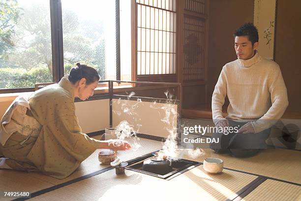 man attending japanese tea ceremony, front view, side view, japan - bamboo dipper stock-fotos und bilder