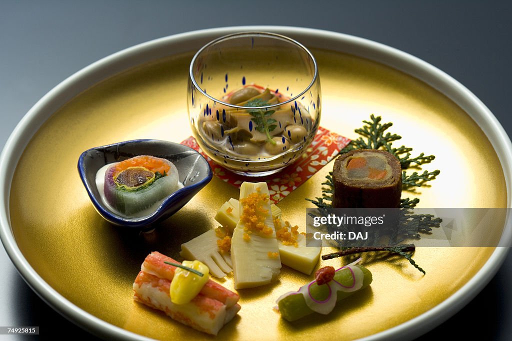 Various Japanese food on a plate, high angle view, black background, Japan