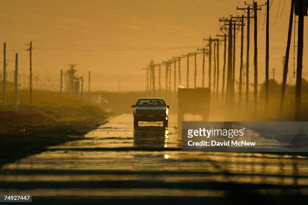 Mirage creates the illusion of water on a dry highway on a hot summer day as drought conditions worsen on June 25, 2007 near Bakersfield, California....