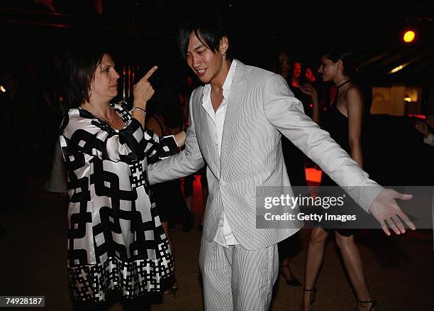 Peter Ho of China dances with an unidentified guest as he attends the Tag Heuer Grand Carrera Event, on June 26, 2007 in Le Castellet, France.