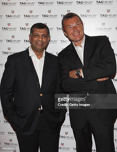 Air Asia C.E.ODato Tony Fernandez of Malaysia poses with Tag Heuer watches company C.E.O Jean-Christophe Babin as he arrives to attend the Tag Heuer...