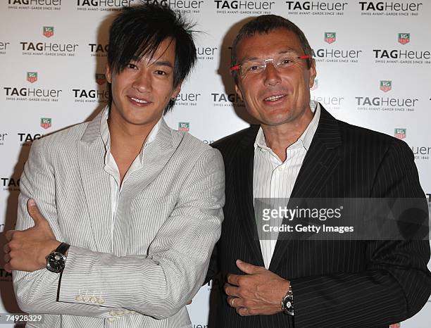 Peter Ho of China poses with Tag Heuer watches company C.E.O Jean-Christophe Babin as he arrives to attend the Tag Heuer Grand Carrera event on June...