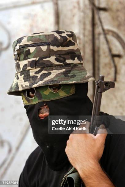 Masked Palestinian member of the Islamic Jihad Movement takes up his position during clashes on June 27, 2007 in Gaza City, Gaza Strip. Israeli...