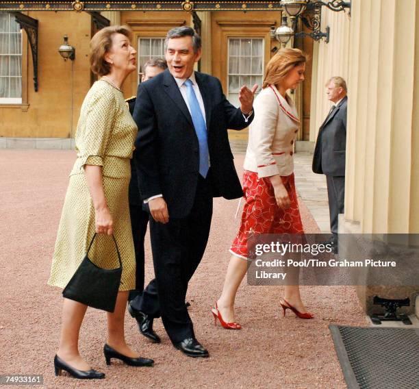 Gordon Brown, accompanied by his wife Sarah Brown, is greeted by the Queen's Lady In Waiting, Lady Hussey, as he arrives at Buckingham Palace to be...