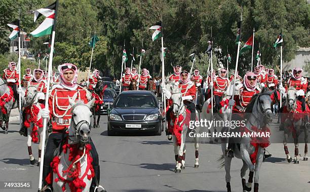 Mounted honour guard escorts a convoy of cars bearing Jordanian King Abdullah II and visiting Saudi King Abdullah bin Abdul Aziz al-Saud in Amman, 27...