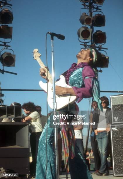 Rock guitarist Jimi Hendrix performs onstage with his Fender Stratocaster electric guitar at the Newport Pop Festival on June 20, 1969 in Devonshire...