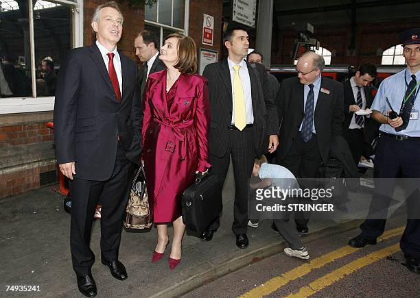Trimdon, UNITED KINGDOM: Former British Prime Minister Tony Blair waits for his car with his wife Cherie at Darlington railway station as he headed...