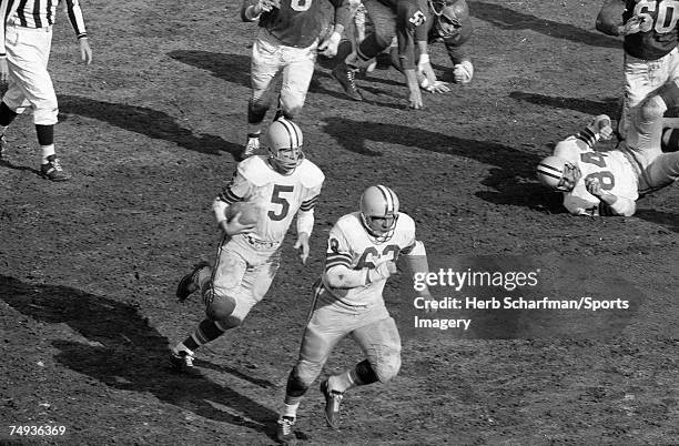 Paul Hornung of the Green Bay Packers carries the ball as Fred Thurston of the Green Bay Packers blocks for him against the Philadelphia Eagles in...