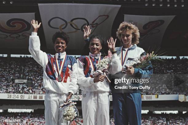Florence Griffith-Joyner of the United States celebrates winning the gold medal in the Women's 100 metres final event with second placed silver...