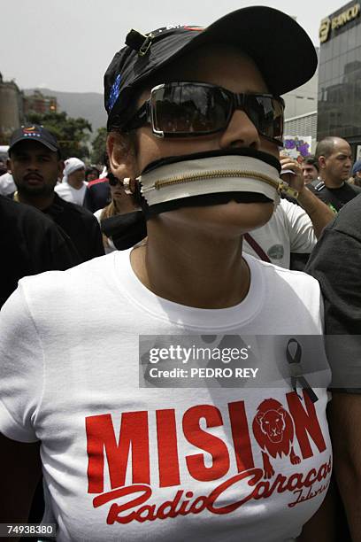 Woman with her mouth "zipped" marchs along with journalists during the National Journalist Day in Caracas, 27 June, 2007. Workers of the radio...