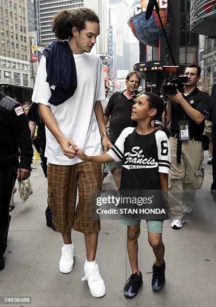 New York, UNITED STATES: Joakim Noah of Florida, one of the top NBA draft prospects greets a fan 27 June 2007 in New York's Times Square, one day...