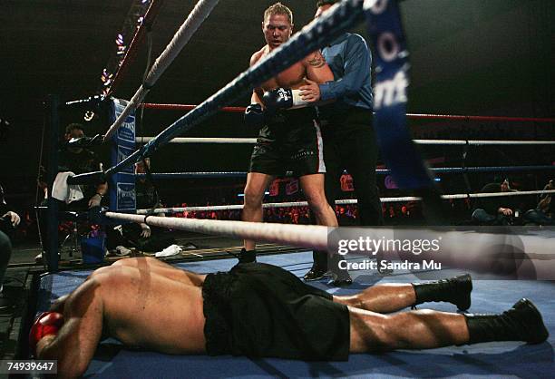 Shane Cameron of New Zealand looks over Jucimar Francisco Hipolito after he knocked him through the ropes during the IBF Pan Pacific Heavyweight, WBA...