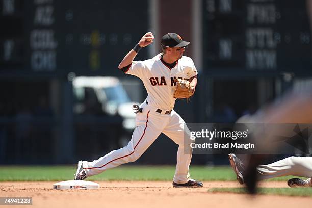 Kevin Frandsen of the San Francisco Giants turns a double play at second base during the game against the San Diego Padres at AT&T Park in San...