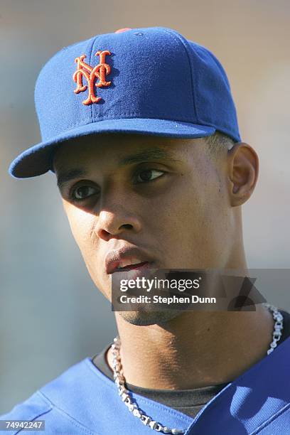 Carlos Gomez of the New York Mets waits his turn to take batting practice before the game with the Los Angeles Dodgers at Dodger Stadium June 13,...