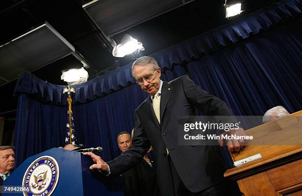 Senate Majority Leader Harry Reid looks downward during a press conference following the defeat of an immigration bill procedural vote on Capitol...