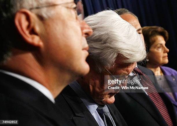 Sen. Ted Kennedy look downward during a press conference with Sen. Ken Salazar , and Sen. Dianne Feinstein following the defeat of an immigration...