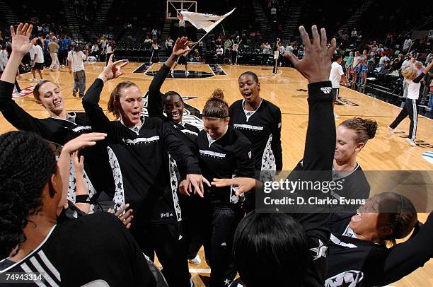 Erin Buescher of the San Antonio Silver Stars, center, celebrates with her teammates before the start of the WNBA game against the Minnesota Lynx on...