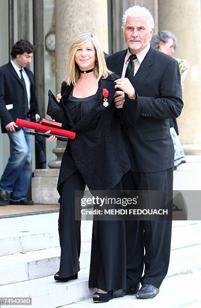 Singer Barbra Streisand poses with her husband James Brolin as she leaves the Elysee Palace after being awarded by French President Nicolas Sarkozy...